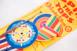 Mid-century Spin the Tops toy showing colorful airplane design and striped disc.
