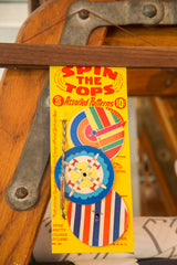 Blue and yellow paper airplane top from a Mid Century Spin the Tops toy.