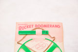Pearson's Rocket Boomerang green plastic toy in original peach colored packaging.