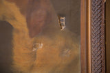 Antique dog portrait painting with two holes in the canvas, framed in carved wood.