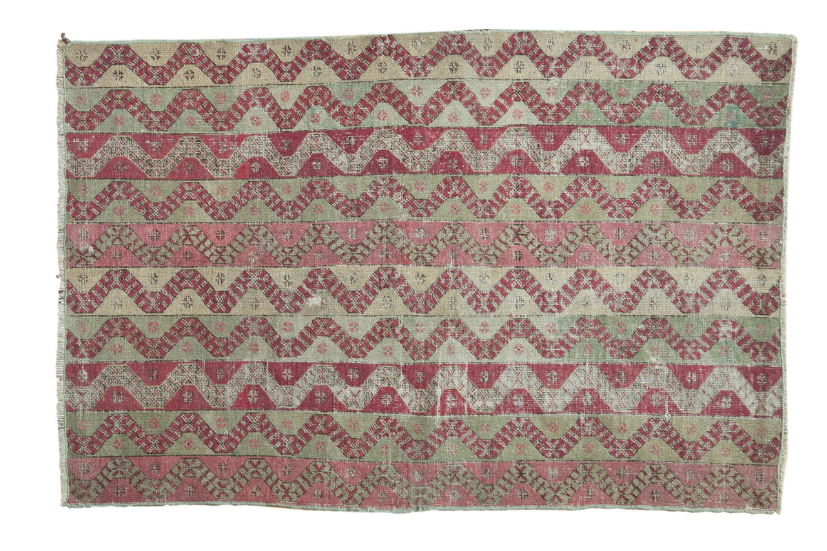 Decorative distressed antique Anatolian rug with celadon, blush, and madder red water motifs.