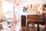Pair of black beeswax taper candles with white wicks, held in hand.