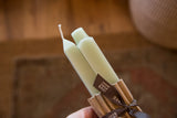 Hand-finished tops and wicks of a pair of celadon green square beeswax candles.
