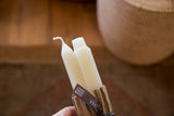 Cream square beeswax taper candles featuring exposed wick and '100% Pure Beeswax' ribbon.