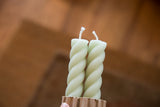 Celadon beeswax rope taper candles, revealing the unique twisted design and wicks.