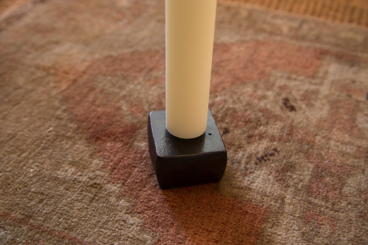 Made in NY Cast Iron Candle Holder with matte finish, holding a white taper.
