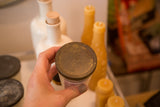 Aged, textured zinc lid with subtle stamp on a vintage jelly jar candle.