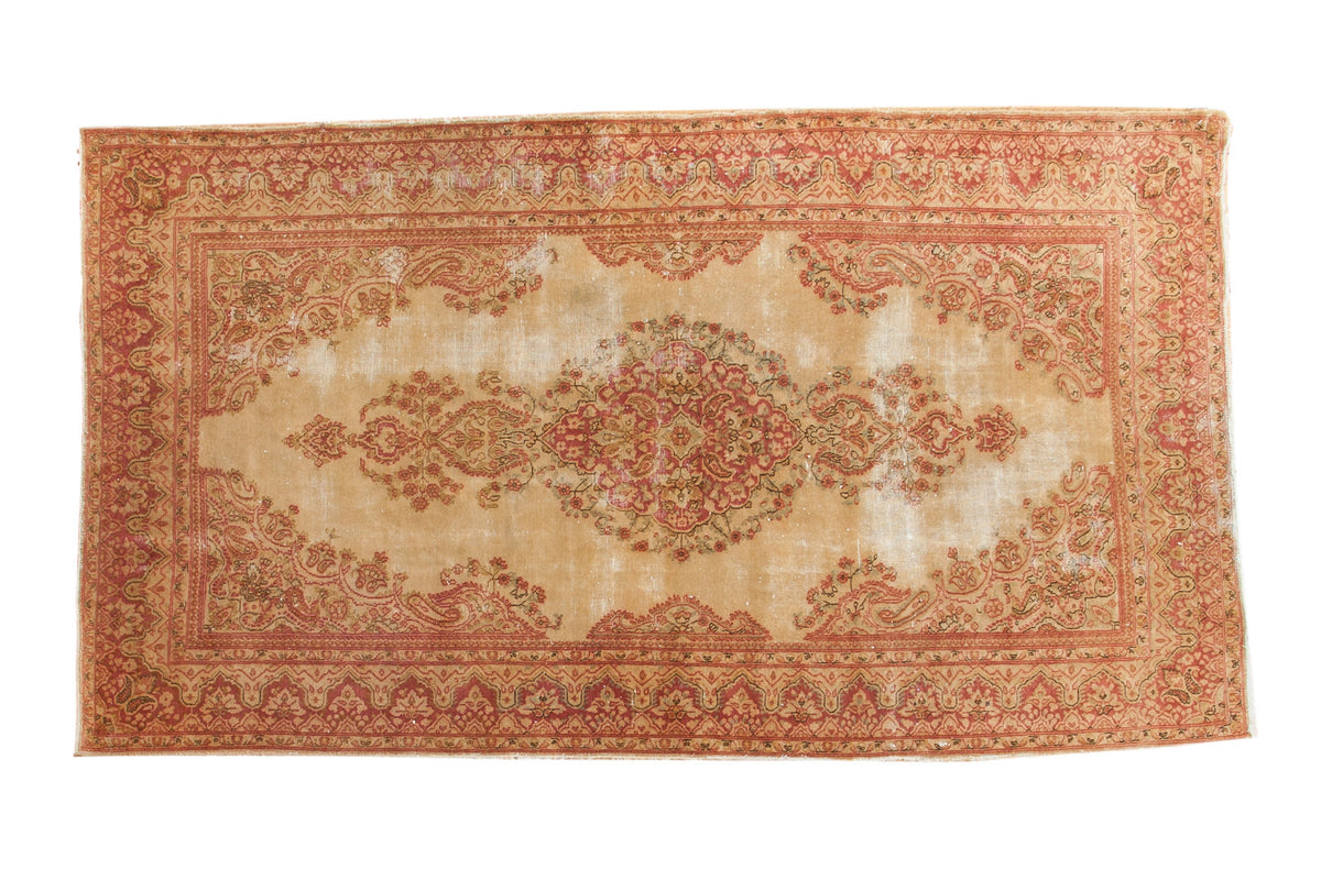 Distressed vintage Persian Kerman rug, faded raspberry floral medallion on an antique cream field, 4x7.5.