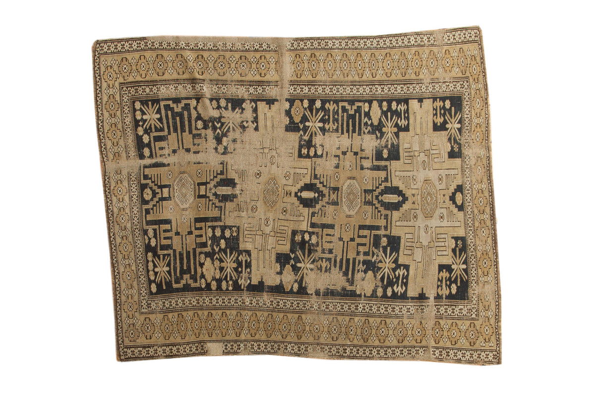 Distressed Antique Shirvan rug with geometric starburst medallions, patina navy blue and beige, early 20th century, 4'2" x 4'8".