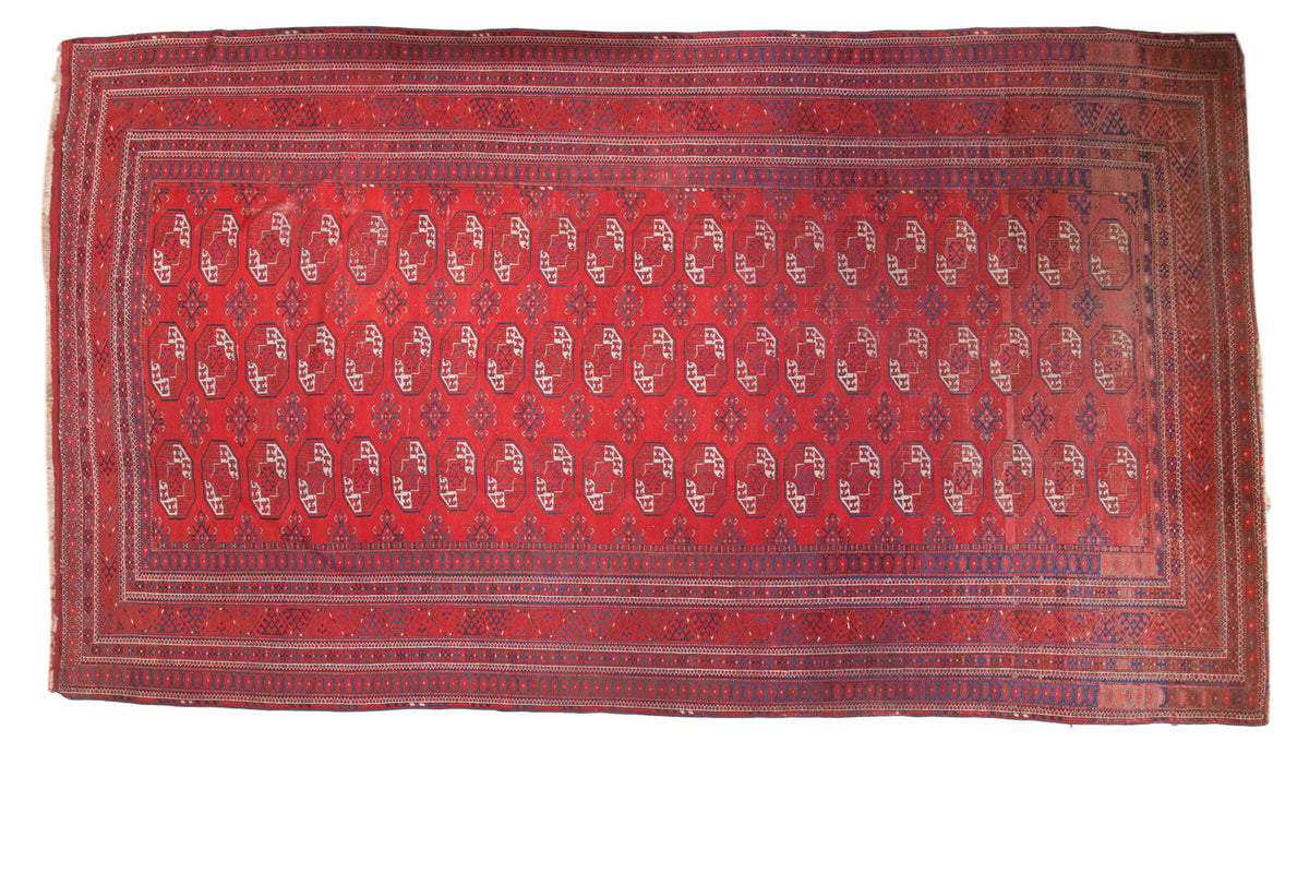 Vintage Afghan Bokhara carpet, allover triple gul design, intricate border in brick red and indigo blue.
