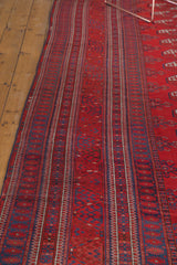 Intricate vertical striped border in rich red and indigo blue on a vintage Afghan Bokhara rug.
