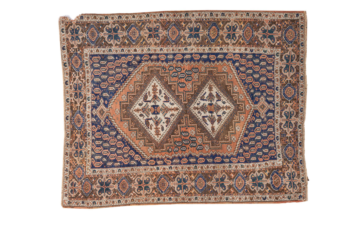 Antique Afshar rug featuring double diamond medallions, stylized birds, boteh, navy blue and apricot.
