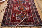 Textured vintage Karaja rug with geometric-curvilinear motifs in cherry red, navy, sky blue, ivory.