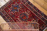 Vintage Karaja rug section with intricate geometric and curvilinear patterns in red, navy, and ivory.
