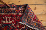 Vintage Karaja rug showing hand-knotted reverse, geometric pattern, and ivory fringe.