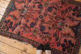 Faded cranberry Persian Lilihan rug with sprawling teal, blue, gold floral vinery.