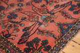 Vintage Lilihan rug corner: faded cranberry field, blossoming vinery, and tattered blue border.