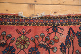Tattered end of a Vintage Lilihan rug, featuring patterned borders and cranberry floral motifs.