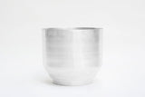 Brushed silver aluminum planter with modern cylindrical shape and tiered base.