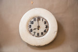 Rustic chipped white paint on the vintage folk art clock face and frame.