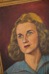 Woman's face in the mid-century oil painting with bright eyes against a burgundy background.