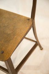 Aged wooden seat and dark metal frame of the Toledo kid's chair.