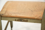 Close-up of Toledo Metal Furniture Co. label on the chair's light green metal frame.