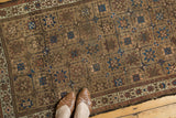 Antique Belouch runner's repeating starburst gul motif and pinwheels in camel and sky blue.