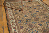 Antique Belouch runner's geometric starburst gul motif in camel, blue, red tones, with evenly worn pile.