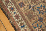 Detail of the antique Belouch runner's secure side, highlighting camel, sky blue, and madder root red geometric motifs.