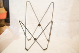 Detail of the Mid Century butterfly chair frame's lower metal structure and aged joints.