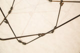Angled view of the vintage 1960s butterfly chair frame's worn metal connections.