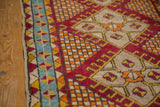 Vintage Yastic rug: teal aqua geometric border, cherry red main border, tangerine checkered field.