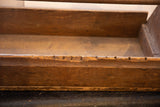 Rustic interior detail of vintage wooden toolbox with aged patina and top edge holes.