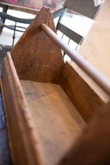 Interior of the vintage wooden toolbox, revealing its aged wood grain and deep patina.