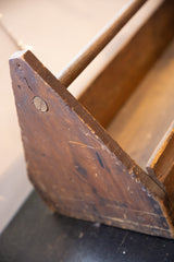 Weathered wood detail of the vintage toolbox, featuring a round plug and rich patina.