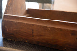 Close-up side of primitive vintage wooden toolbox, rustic wood grain, rich patina.