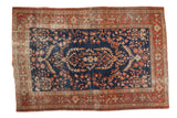 Antique Farahan Sarouk rug, deep indigo, diminutive medallion, serrated leaves, terra cotta border.