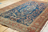 Antique Farahan Sarouk rug detail showing harmonious serrated leaves and floral vines.