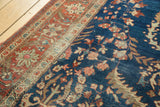 Serrated leaves and vines on deep indigo field, contrasting rich terra cotta border motifs.
