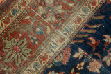 Antique Farahan Sarouk rug's terra cotta border, indigo field, serrated leaves, visible wear.