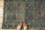 Antique Lilihan rug's veramin allover floral lattice in sky blue, madder red, with visible wear.