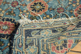 Antique Lilihan rug's hand-knotted foundation, intricate geometric weave in blues and beige, with tattered fringe.