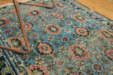 Worn sky blue field of an antique Lilihan rug with madder red veramin floral lattice.