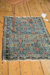 Antique Lilihan rug corner detail, highlighting tattered fringe, dark indigo border, and sky blue floral field.