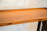 Close-up of the warm reclaimed wood top with a slotted front edge.