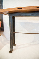 Distressed dark iron leg and crossbar of the Industrial Work Table.