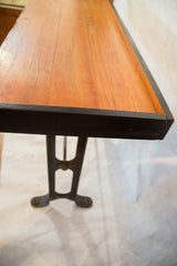 Reclaimed dark vintage iron base and bolted feet of the industrial table.