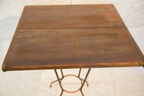 Reclaimed wood square tabletop with visible grain and warm brown tones.