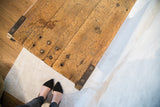 Rustic industrial reclaimed wood coffee table top with rich patina and metal corner hardware.